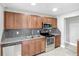 Updated kitchen featuring stainless steel appliances, wood cabinets and granite counters at 3702 W Reynolds St, Plant City, FL 33563