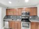 Charming kitchen showcasing stainless steel appliances, granite countertops, and tile backsplash at 3702 W Reynolds St, Plant City, FL 33563