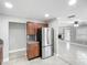 Open kitchen featuring stainless steel appliances and dark wood cabinetry with granite countertops at 3702 W Reynolds St, Plant City, FL 33563