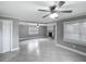 Large living area showcasing neutral gray paint, tile flooring and a cozy fireplace at 3702 W Reynolds St, Plant City, FL 33563