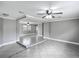 Open-concept living room featuring gray walls, tile flooring, and a ceiling fan at 3702 W Reynolds St, Plant City, FL 33563
