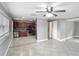 Open layout with tile flooring leading into a kitchen with rich wood cabinetry at 3702 W Reynolds St, Plant City, FL 33563