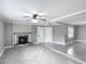 Spacious living area with tile floors, decorative fireplace and neutral gray paint at 3702 W Reynolds St, Plant City, FL 33563