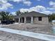 Charming single-story home showcasing brick facade, covered porch, and attached two-car garage on a sunny day at 410 Shannon Estates Ct, Plant City, FL 33563