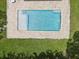 Aerial view of a backyard pool surrounded by a stone patio and manicured lawn at 4501 Huntington Ne St, St Petersburg, FL 33703