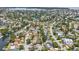 Aerial view of neighborhood with the home indicated by a red arrow, set amongst mature trees at 4501 Huntington Ne St, St Petersburg, FL 33703