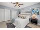 Cozy bedroom featuring a ceiling fan, white bedding, and stylish nightstands at 4501 Huntington Ne St, St Petersburg, FL 33703