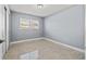 Cozy bedroom with a window, neutral walls, and a closet; carpeted floor at 4501 Huntington Ne St, St Petersburg, FL 33703