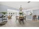 Bright dining area with a round table, stylish chairs, and access to the kitchen and living area at 4501 Huntington Ne St, St Petersburg, FL 33703