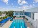 Inviting school exterior featuring a clear pool, a dive board, and a deck with multiple chairs and tables at 4501 Huntington Ne St, St Petersburg, FL 33703