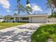 Exterior showcasing a single-story home with a clean facade, attached garage, and a well-kept driveway and lawn at 4501 Huntington Ne St, St Petersburg, FL 33703