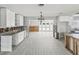 Open-concept kitchen featuring tile floors, an island, views to backyard, and awaiting renovation at 4501 Huntington Ne St, St Petersburg, FL 33703