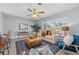 Cozy living room featuring stylish furniture, neutral tones, natural light, and modern ceiling fan at 4501 Huntington Ne St, St Petersburg, FL 33703