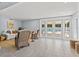 Bright living room with wicker furniture, white sofa and outdoor pool views at 4501 Huntington Ne St, St Petersburg, FL 33703