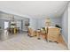Bright open-concept living and dining area with wicker furniture and tile flooring at 4501 Huntington Ne St, St Petersburg, FL 33703