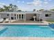 Backyard pool features a covered patio area and poolside lounge chairs at 4501 Huntington Ne St, St Petersburg, FL 33703