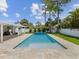 Beautiful backyard featuring a sparkling swimming pool, complemented by lush greenery and well-manicured landscaping at 4501 Huntington Ne St, St Petersburg, FL 33703