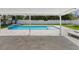 Backyard pool surrounded by an extensive patio area that is partially covered at 4501 Huntington Ne St, St Petersburg, FL 33703