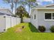 Grassy side yard surrounded by a white privacy fence, offering a secluded outdoor space at 4501 Huntington Ne St, St Petersburg, FL 33703