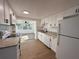 Bright kitchen featuring granite counters, white cabinets, and modern appliances at 4623 Irene Loop, New Port Richey, FL 34652