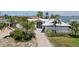 An aerial view showing the front facade, lush palm trees, and waterway location at 511 64Th Ave, St Pete Beach, FL 33706
