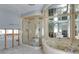 Bathroom featuring a glass shower, soaking tub, and mirrored accents at 511 64Th Ave, St Pete Beach, FL 33706