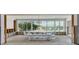 Bright dining room with clear table and chairs overlooking waterfront views through large windows at 511 64Th Ave, St Pete Beach, FL 33706