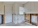 Kitchen area with white cabinets and door to outside at 511 64Th Ave, St Pete Beach, FL 33706