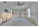 Spacious living room featuring a ceiling fan and natural light ready for renovation at 511 64Th Ave, St Pete Beach, FL 33706