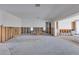 Open concept living room in renovation stage with exposed studs and concrete flooring at 511 64Th Ave, St Pete Beach, FL 33706