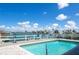 Enjoy a backyard pool with a spacious deck, water view, and blue heron decor at 511 64Th Ave, St Pete Beach, FL 33706