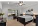 Comfortable bedroom featuring a large window, carpeted flooring, and elegant décor, creating a serene atmosphere at 6011 Caldera Ridge Dr, Lithia, FL 33547