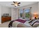 Bedroom features windows, bed with a patterned quilt, dresser, and ceiling fan at 6011 Caldera Ridge Dr, Lithia, FL 33547