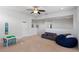 Bright bonus room offering versatile space with a cozy couch, a play table, and carpeted floors at 6011 Caldera Ridge Dr, Lithia, FL 33547