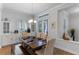 Bright dining room featuring a wooden table, neutral-toned chairs, and built-in cabinetry for elegant storage and display at 6011 Caldera Ridge Dr, Lithia, FL 33547