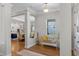 Bright foyer featuring hardwood floors, elegant columns, and a view into the open-concept kitchen and dining area at 6011 Caldera Ridge Dr, Lithia, FL 33547