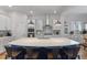 Spacious kitchen with a large center island, white cabinetry, and modern appliances, perfect for culinary enthusiasts at 6011 Caldera Ridge Dr, Lithia, FL 33547