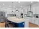 Bright kitchen features a large island with seating, stainless steel appliances, and pendant lighting for a modern look at 6011 Caldera Ridge Dr, Lithia, FL 33547