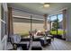 Inviting screened lanai with wicker furniture and a view of the backyard and lush landscaping at 6011 Caldera Ridge Dr, Lithia, FL 33547