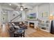 Inviting living room with fireplace, ceiling fan, wood floors, and comfortable gray sofa at 6011 Caldera Ridge Dr, Lithia, FL 33547