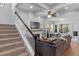 Inviting living room featuring a staircase, comfortable seating, fireplace, and natural light, perfect for relaxation and gatherings at 6011 Caldera Ridge Dr, Lithia, FL 33547