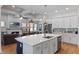 Open concept living space showcasing the kitchen, living room with fireplace, and stainless steel appliances, creating a seamless flow at 6011 Caldera Ridge Dr, Lithia, FL 33547