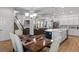 Open-concept living area connecting the dining room, kitchen island, staircase and living room, perfect for modern living at 6011 Caldera Ridge Dr, Lithia, FL 33547