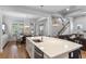 Bright and open living area with kitchen island, dining area, and staircase, perfect for entertaining and everyday living at 6011 Caldera Ridge Dr, Lithia, FL 33547