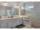 Bright bathroom with double sinks, a glass enclosed shower, and decorative towels at 6011 Caldera Ridge Dr, Lithia, FL 33547