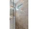 Elegant shower with marble-look tiles, a river rock base, and a glass enclosure, creating a spa-like atmosphere at 6011 Caldera Ridge Dr, Lithia, FL 33547