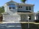 Charming two-story home featuring an attached two-car garage and a well-maintained lawn at 603 5Th S St, Safety Harbor, FL 34695