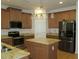 Spacious kitchen with stainless appliances, granite countertops and a center island at 603 5Th S St, Safety Harbor, FL 34695