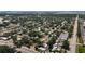 An aerial view captures the expansive neighborhood with tree-lined streets stretching toward the ocean at 6609 Dartmouth N Ave, St Petersburg, FL 33710