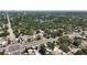 Scenic aerial view of a neighborhood with tree-lined streets, a small lake, and city buildings in the distance at 6609 Dartmouth N Ave, St Petersburg, FL 33710